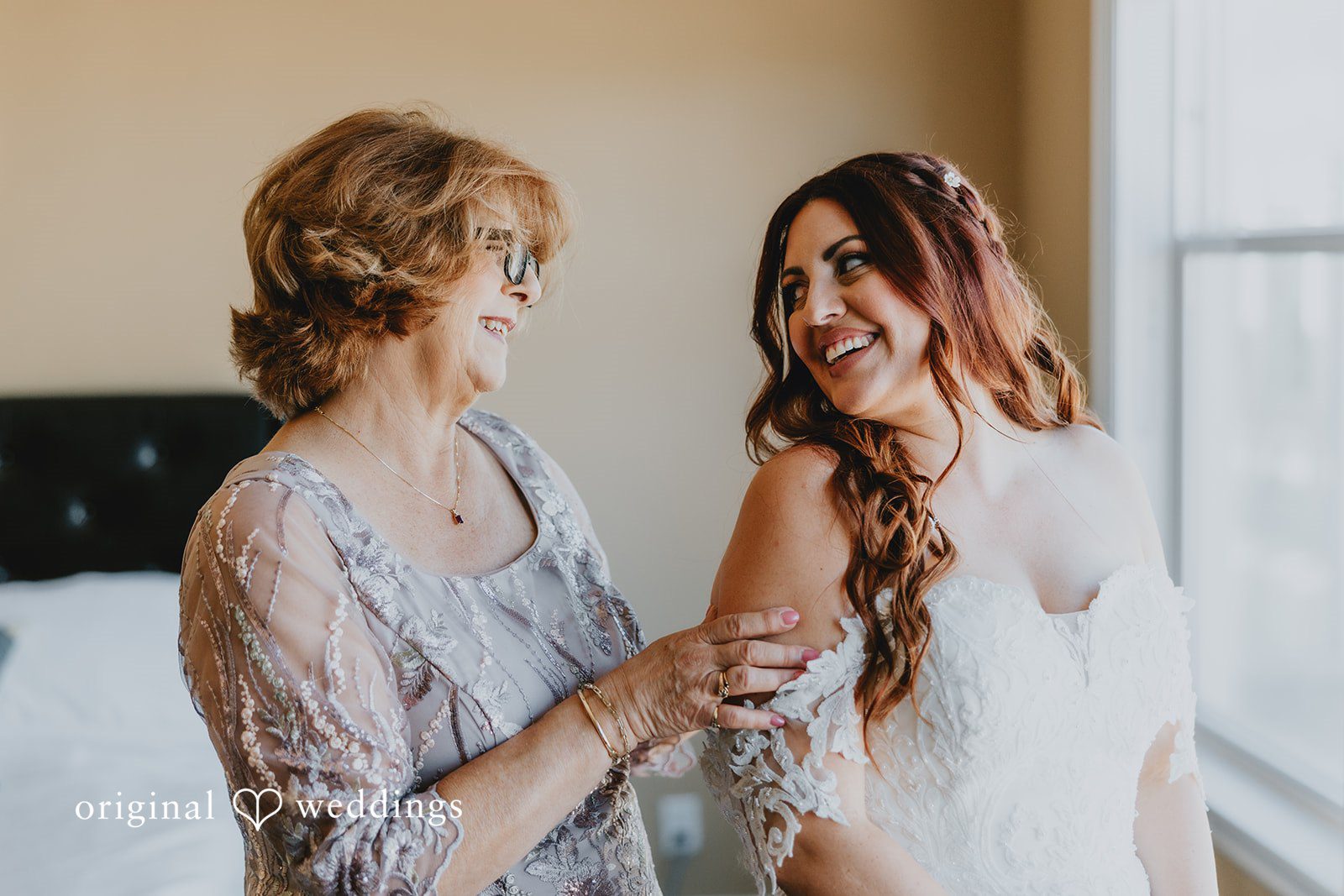 Bride sharing a lovely moment with someone while getting ready