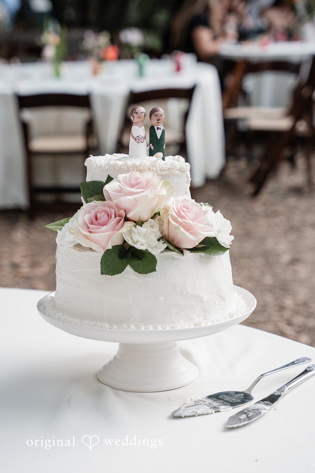 Keely + Sam Beautiful wedding cake decorated with flowers and topper