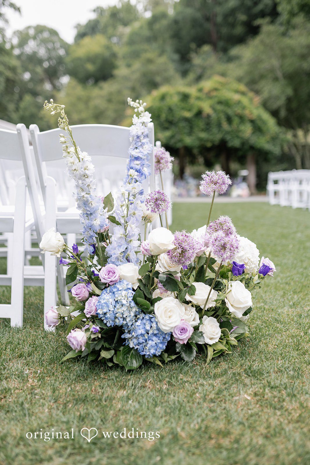 Elegant ceremony floral decor on green lawn