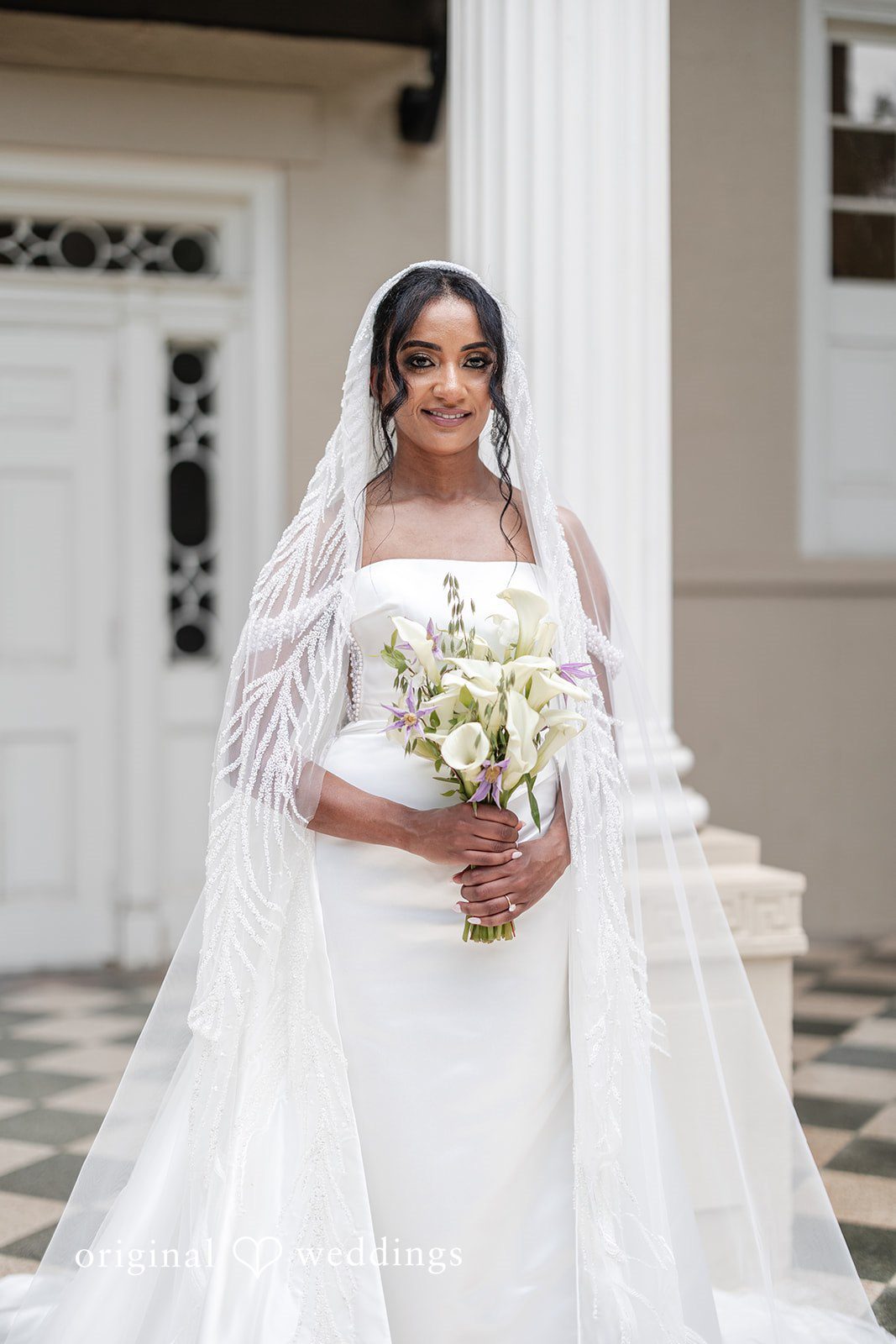Bride holding bouquet in elegant bridal dress