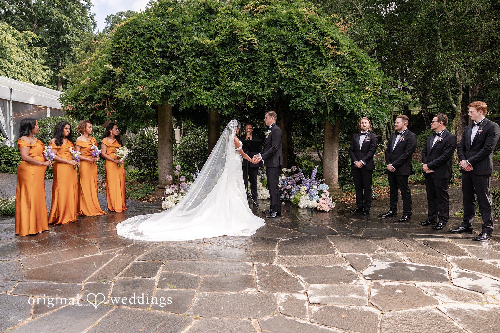 Outdoor wedding ceremony moment at Cator Woolford with floral decor.