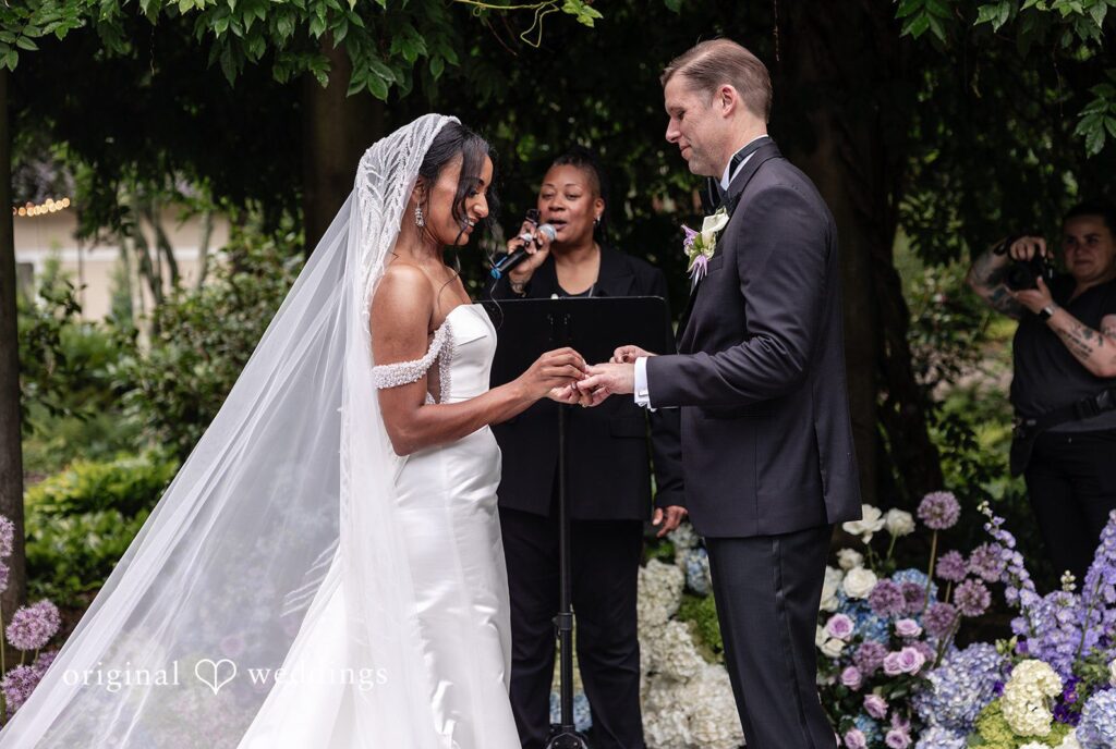 Close-up of bride and groom exchanging rings at Cator Woolford wedding captured by Atlanta wedding photographers from Original Weddings