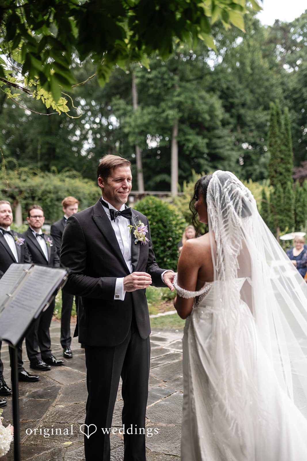 Groom smiling at bride during wedding vows at Cator Woolford.