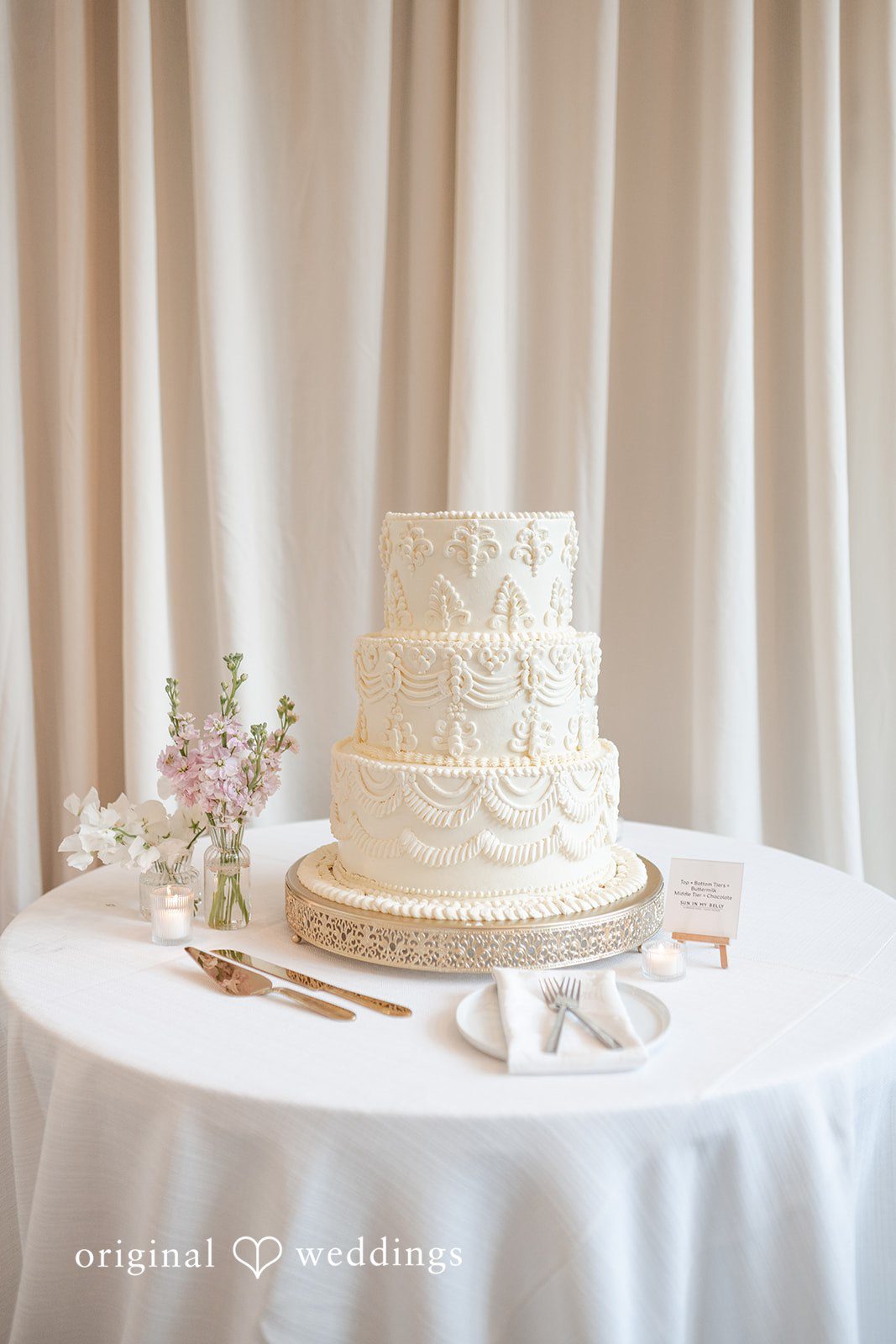 Elegant three-tier white wedding cake