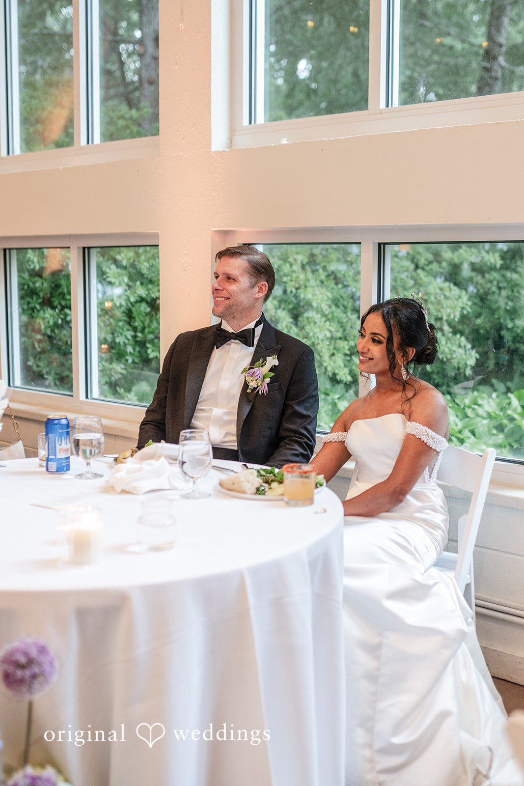 Bride and groom seated at their reception table
