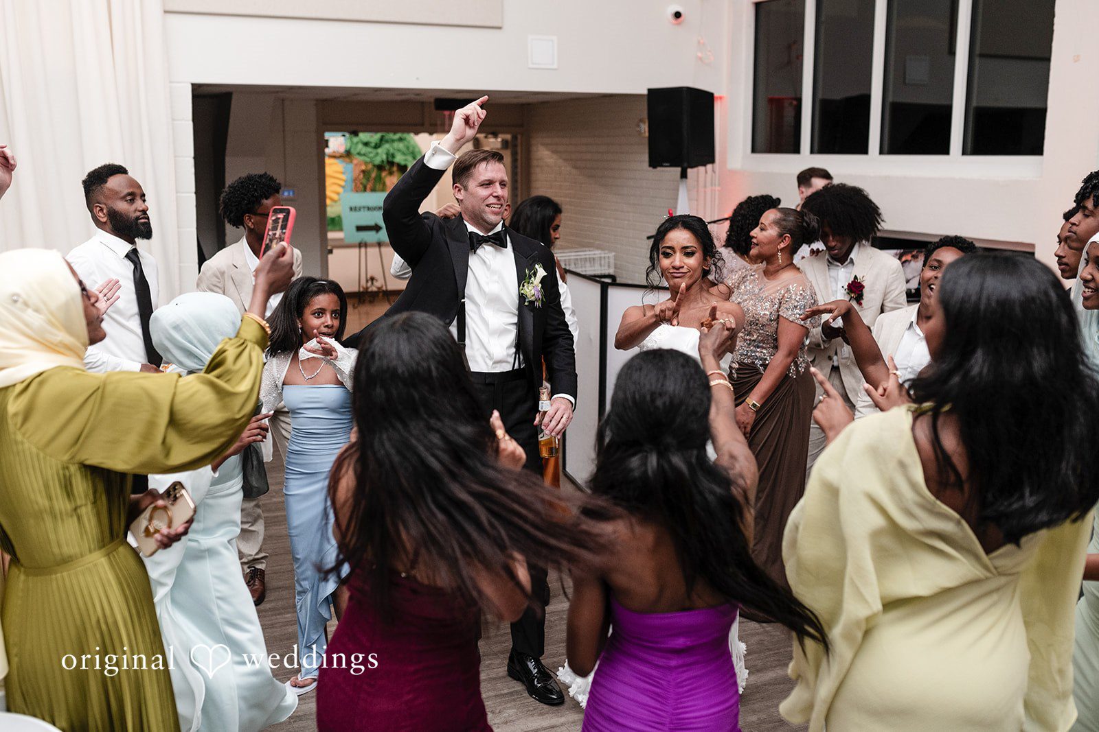Bride and groom dance with guests