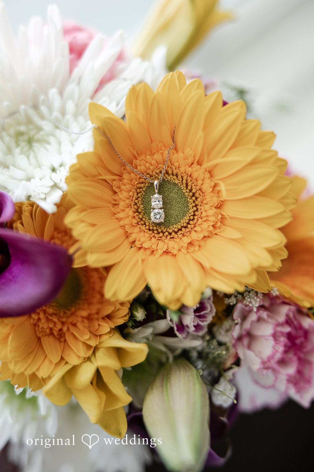 Kellie + AJ Wedding ring nestled inside a floral arrangement
