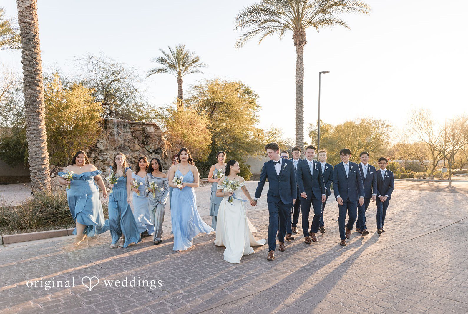 Phoenix wedding photographers by Original Weddings capturing couple group photo with bridesmaids and groomsmen at Colby Falls