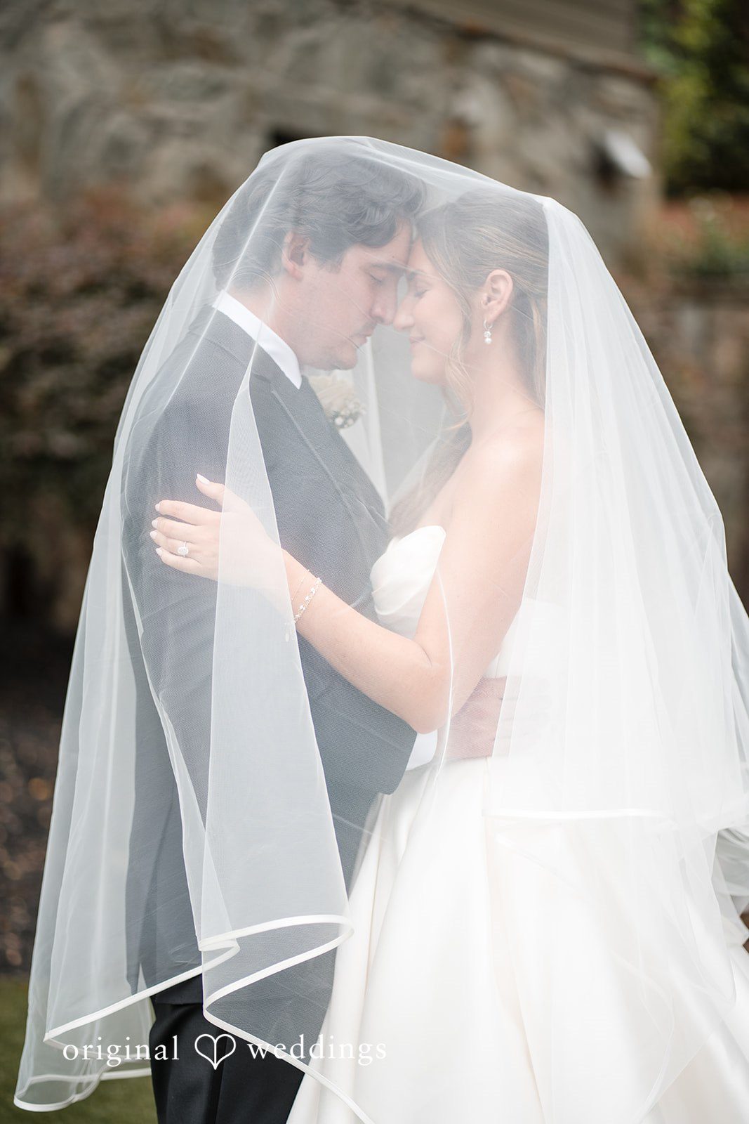 Megan + Grant The couple are wrapped in veil
