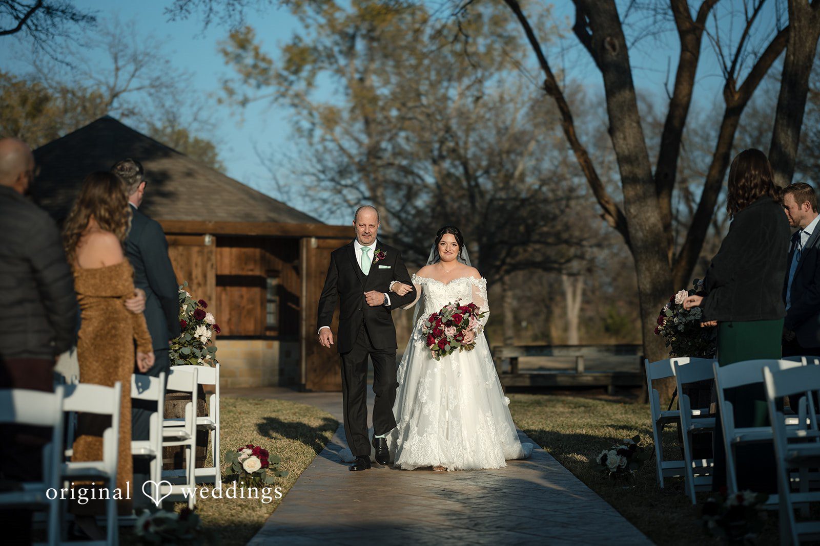 Natalie + Dakin Bride and groom walking down the ceremony aisle together as guests look on.