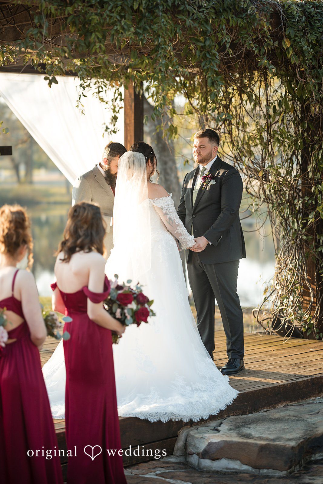 Natalie + Dakin Bride and groom standing together during their ceremony surrounded by the bridal party.