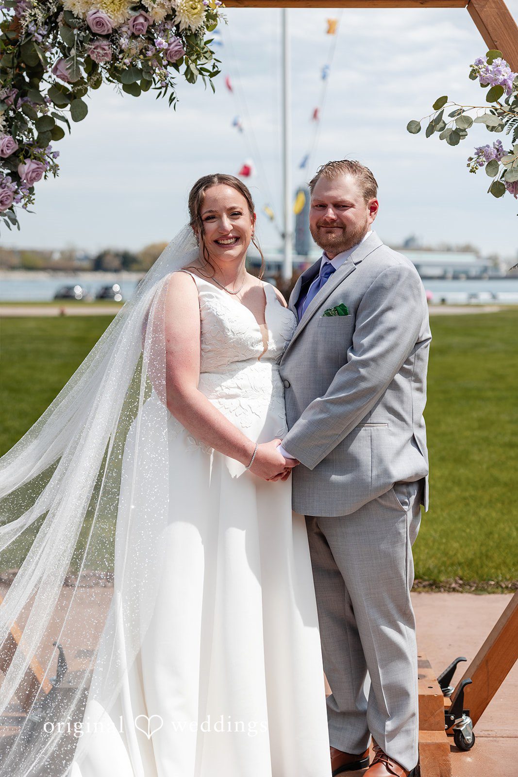 Katelyn + Bradley Bride and groom portrait under the floral arch