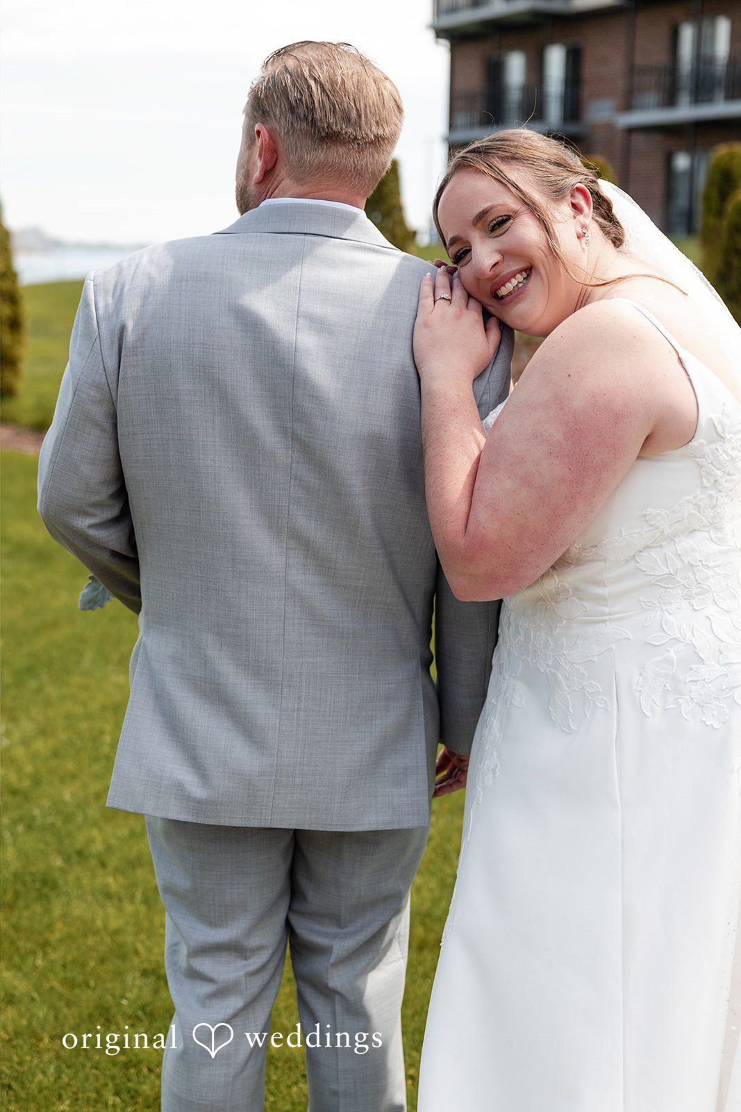 Katelyn + Bradley Bride smiling and leaning on groom’s shoulder during portrait