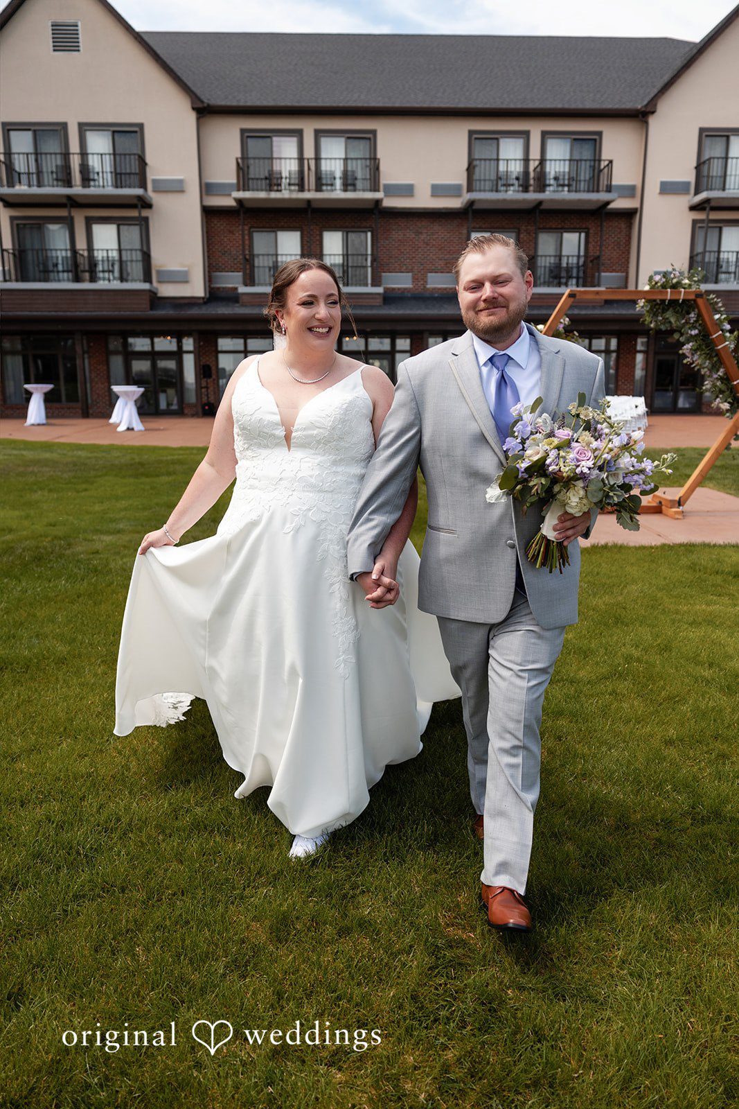 Katelyn + Bradley Bride and groom walking together on the lawn