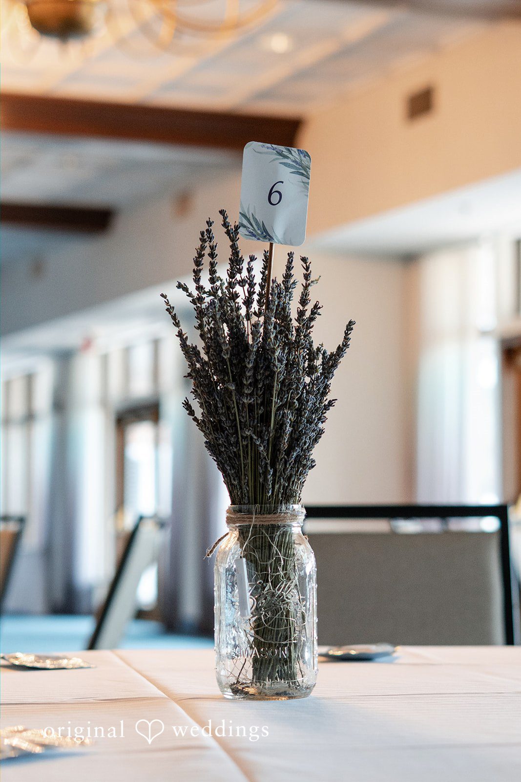 Katelyn + Bradley Lavender table centerpiece with table number six at DoubleTree by Hilton Port Huron.