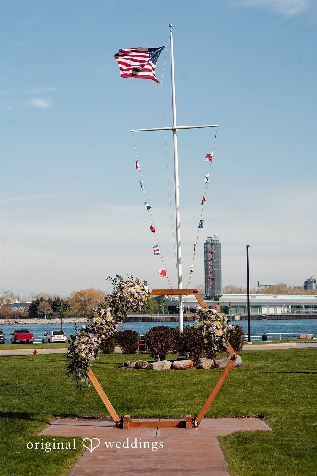 Katelyn + Bradley Floral hexagon wedding arch on the lawn at DoubleTree by Hilton Port Huron.