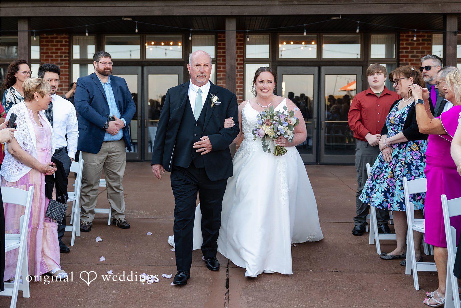 Katelyn + Bradley Bride walking down the aisle with someone