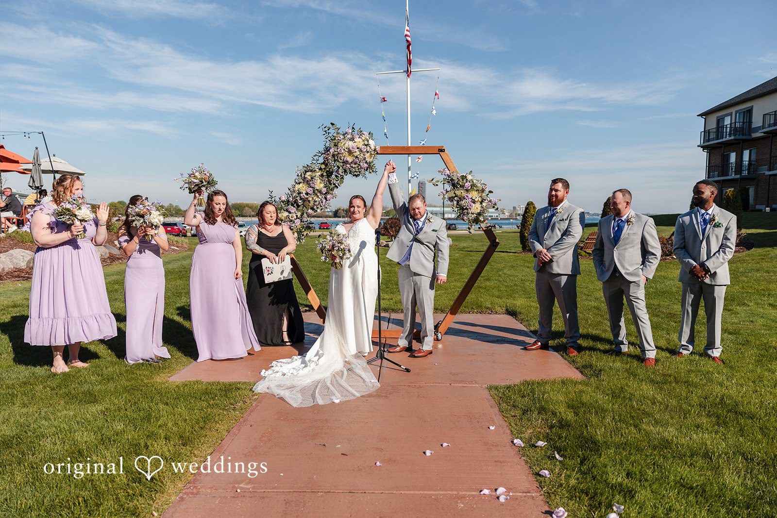 Katelyn + Bradley Bride and groom celebrating their first kiss with the wedding party
