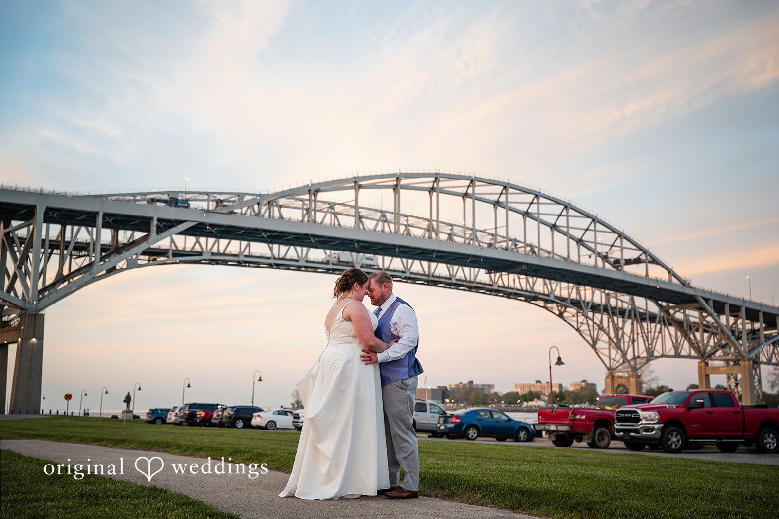 Katelyn + Bradley Bride and groom sharing a sunset portrait with Blue Water Bridge