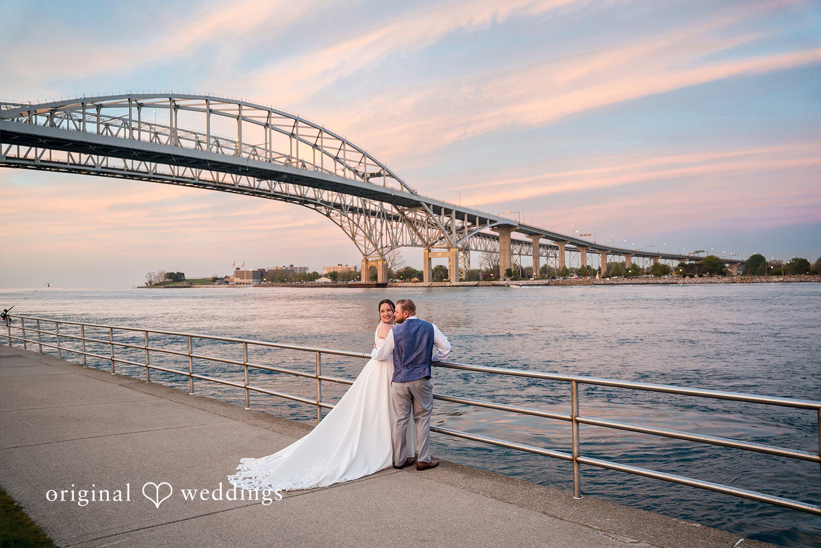 Katelyn + Bradley Bride and groom by the waterfront with Blue Water Bridge at sunset