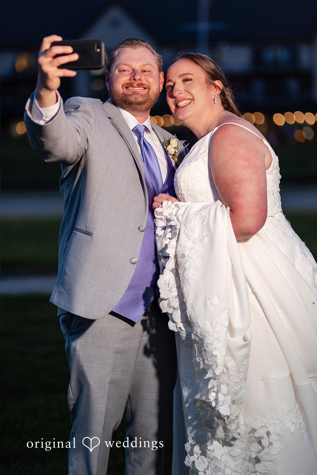Katelyn + Bradley Bride and groom taking a joyful wedding selfie during evening portraits at DoubleTree by Hilton Port Huron.