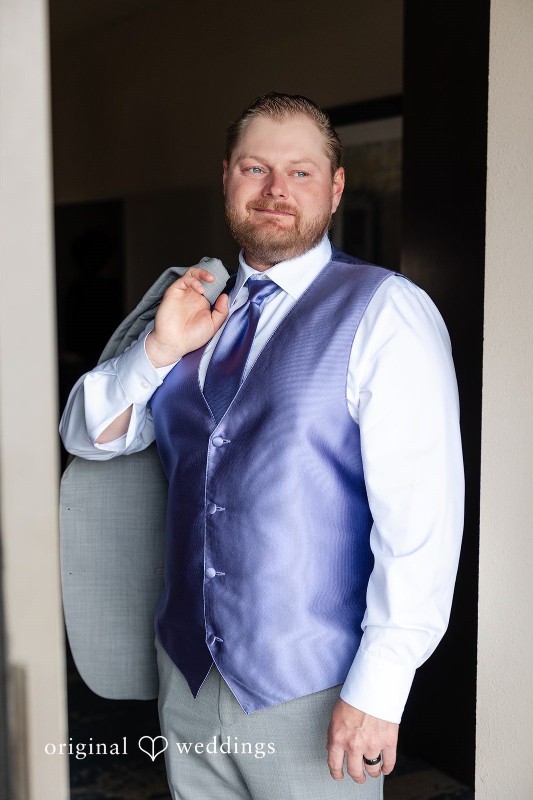 Katelyn + Bradley Groom portrait in lavender vest getting ready at DoubleTree by Hilton Port Huron.
