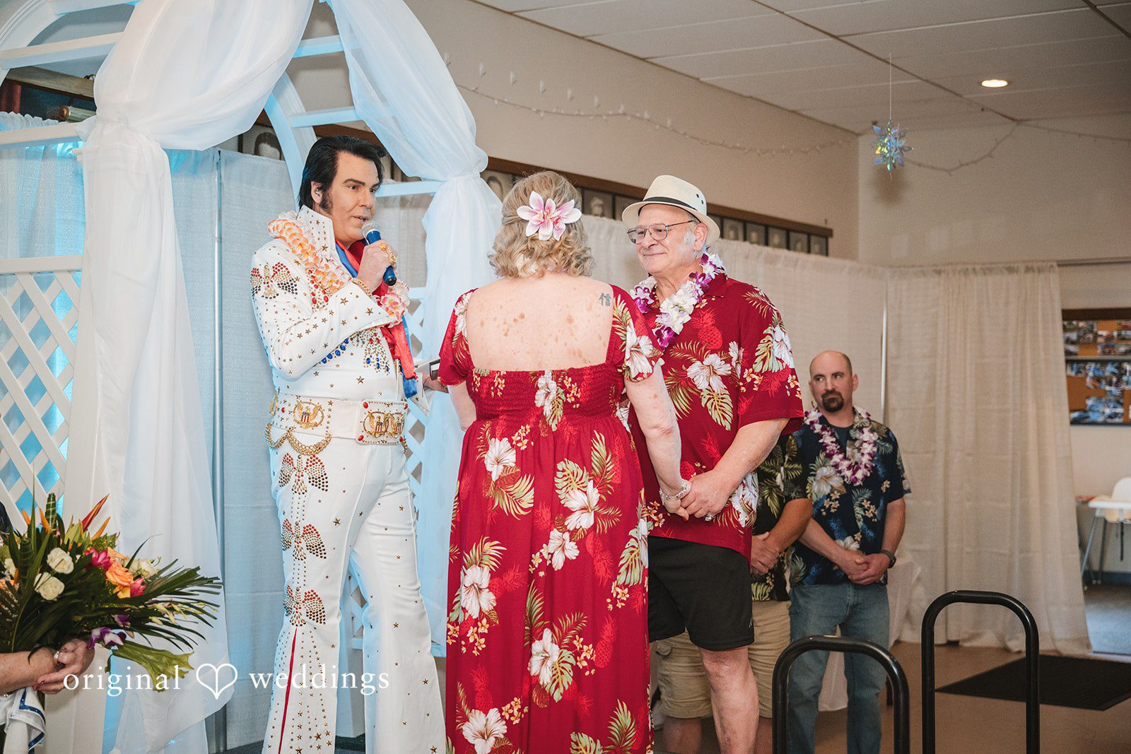 Bride and groom holding hands while listening during the ceremony