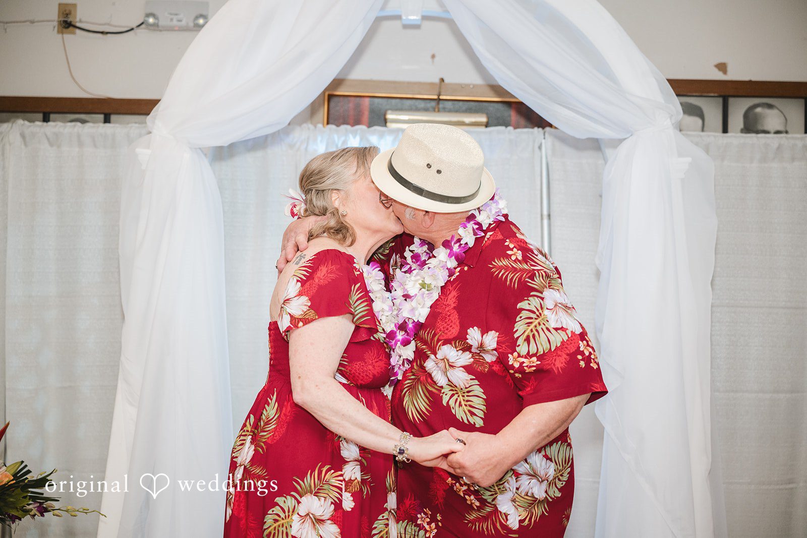 Bride and groom sharing their first kiss after the ceremony