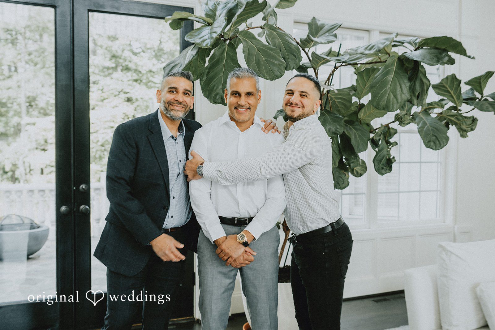 Sunny + Erika Groom posing with his friends before the ceremony