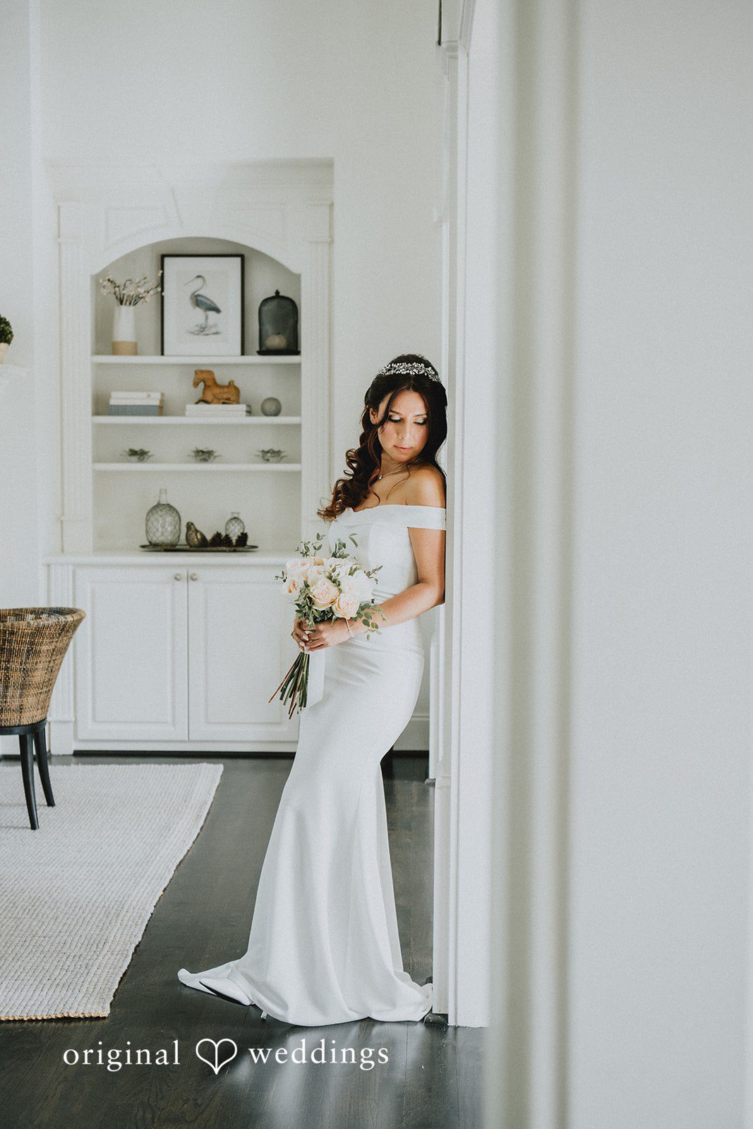 Sunny + Erika Bride posing with her bouquet by the wall