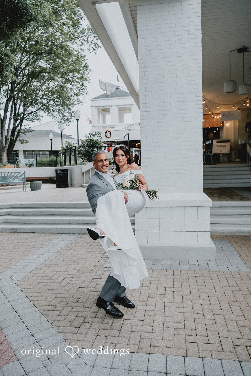 Sunny + Erika Groom carrying the bride during portraits