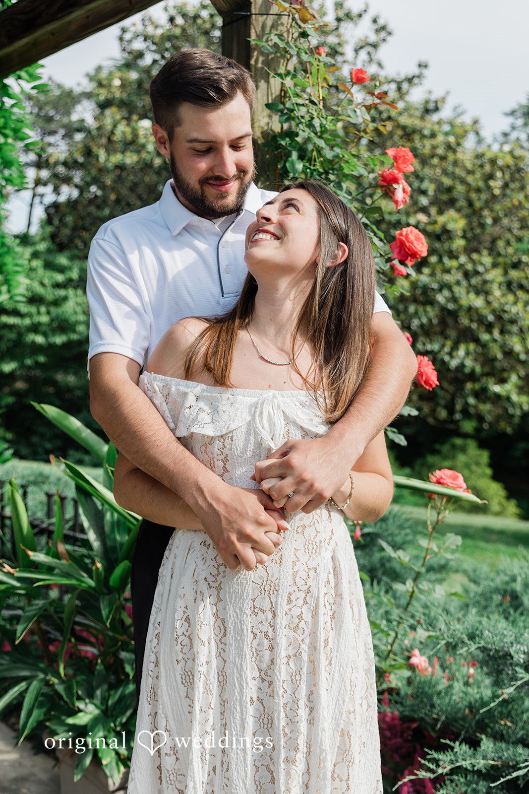 Morgan + Griffin Couple embracing in garden during engagement session at Eden Park in Mt. Adams