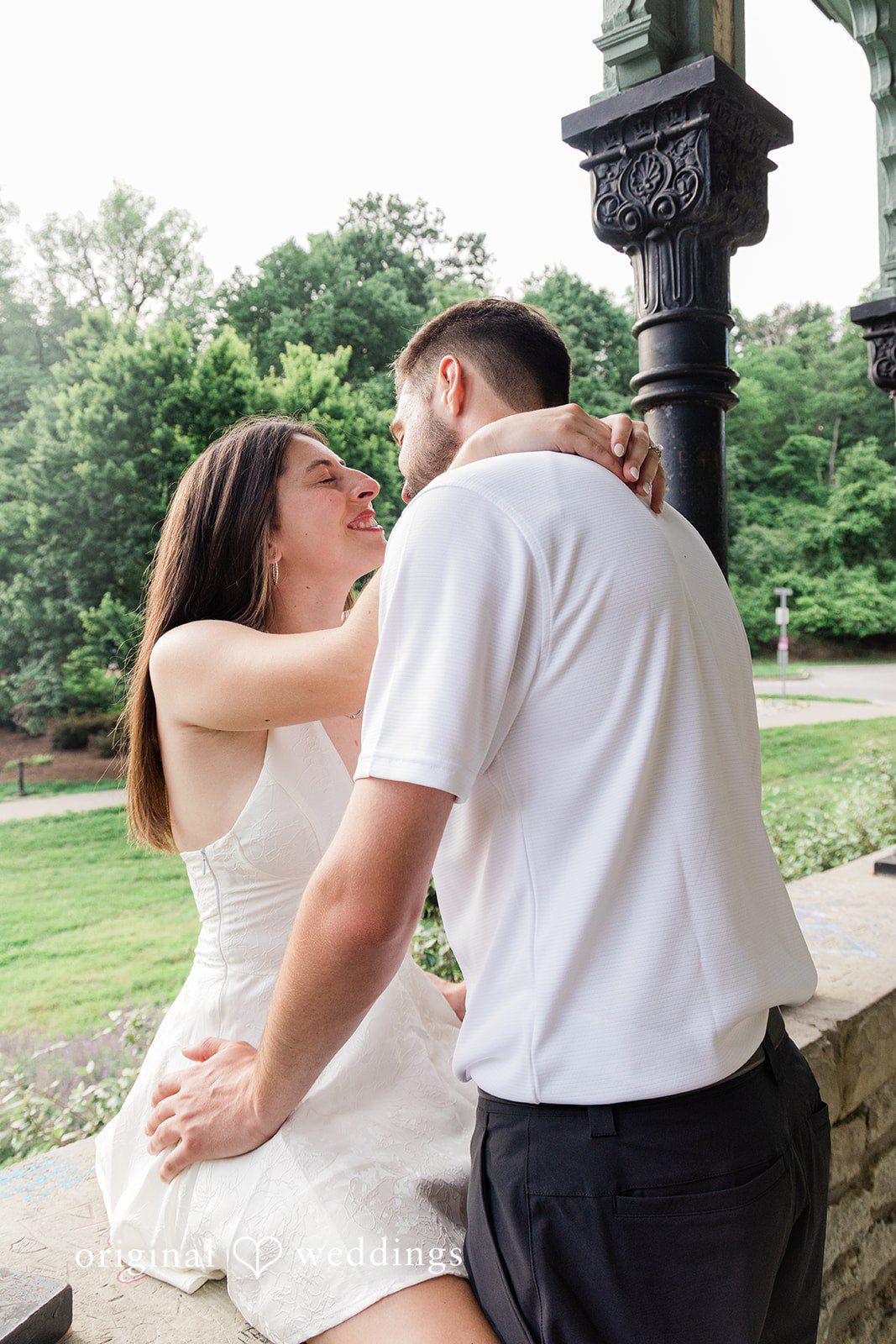 Morgan + Griffin Couple sharing intimate moment under pavilion