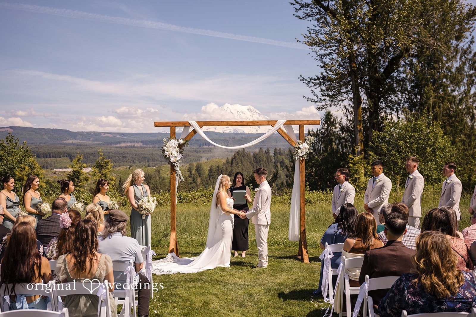 Wide ceremony view with guests and the newlyweds