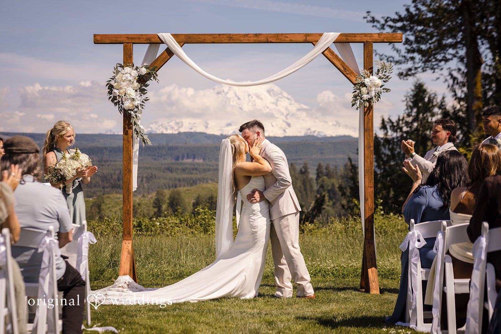 Bride and groom sharing their first kiss after the vows