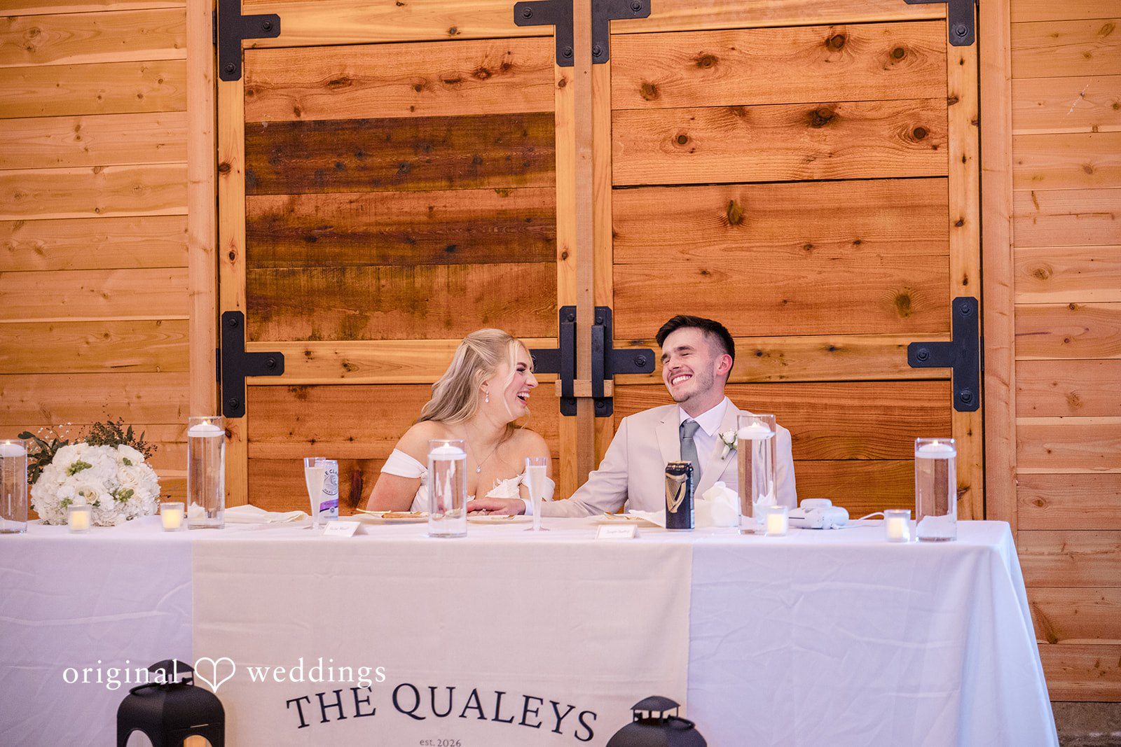 Bride and groom sitting together at their reception table