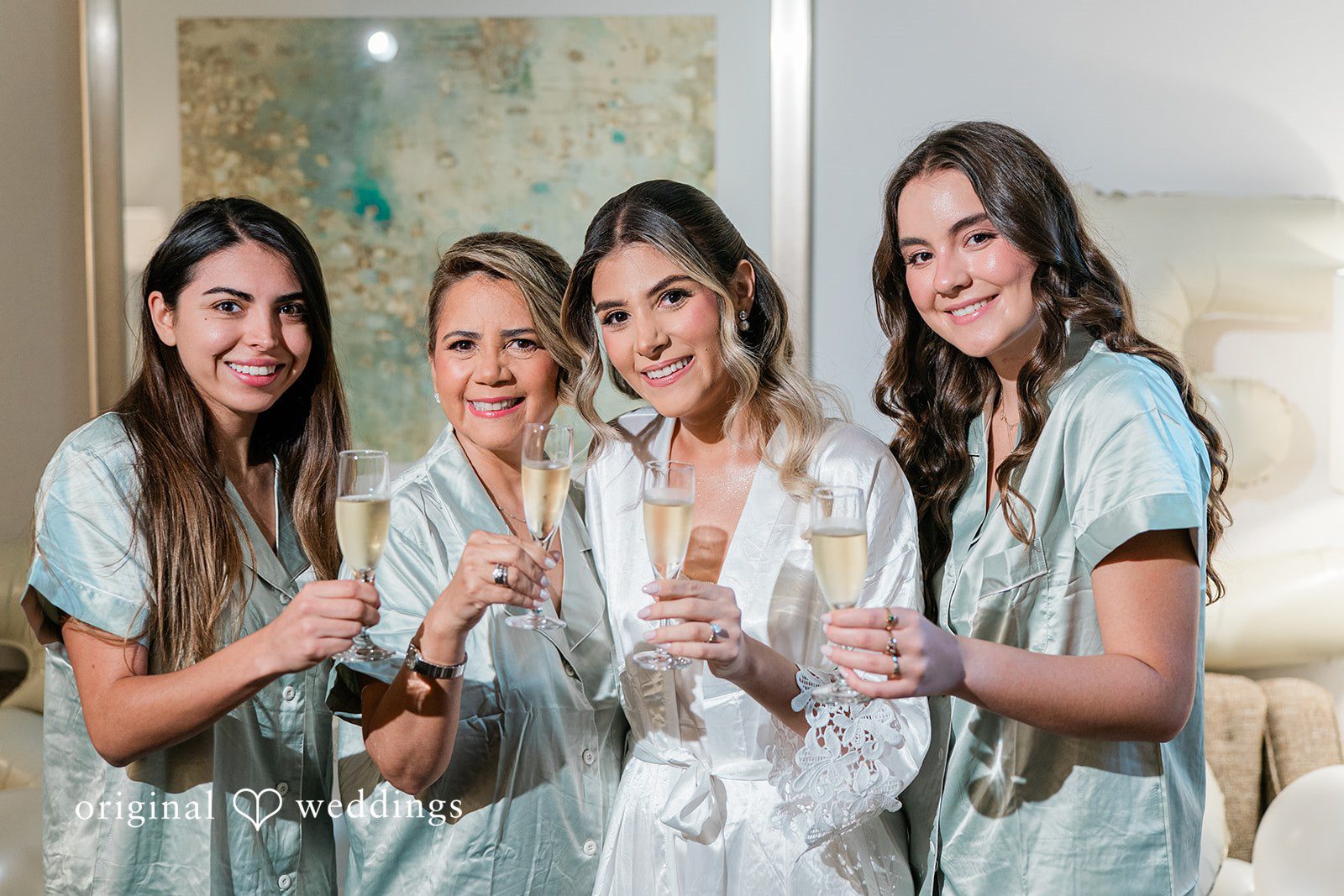 Bride and bridesmaid  smiling and posing together for a photo at Essex Country Country Club.