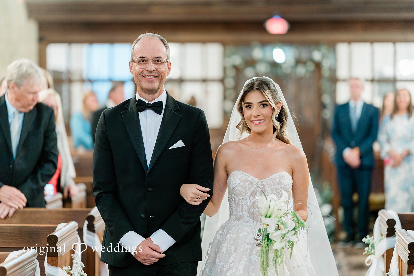 Bride and man smiling as they walk down the aisle at Essex Country Country Club.