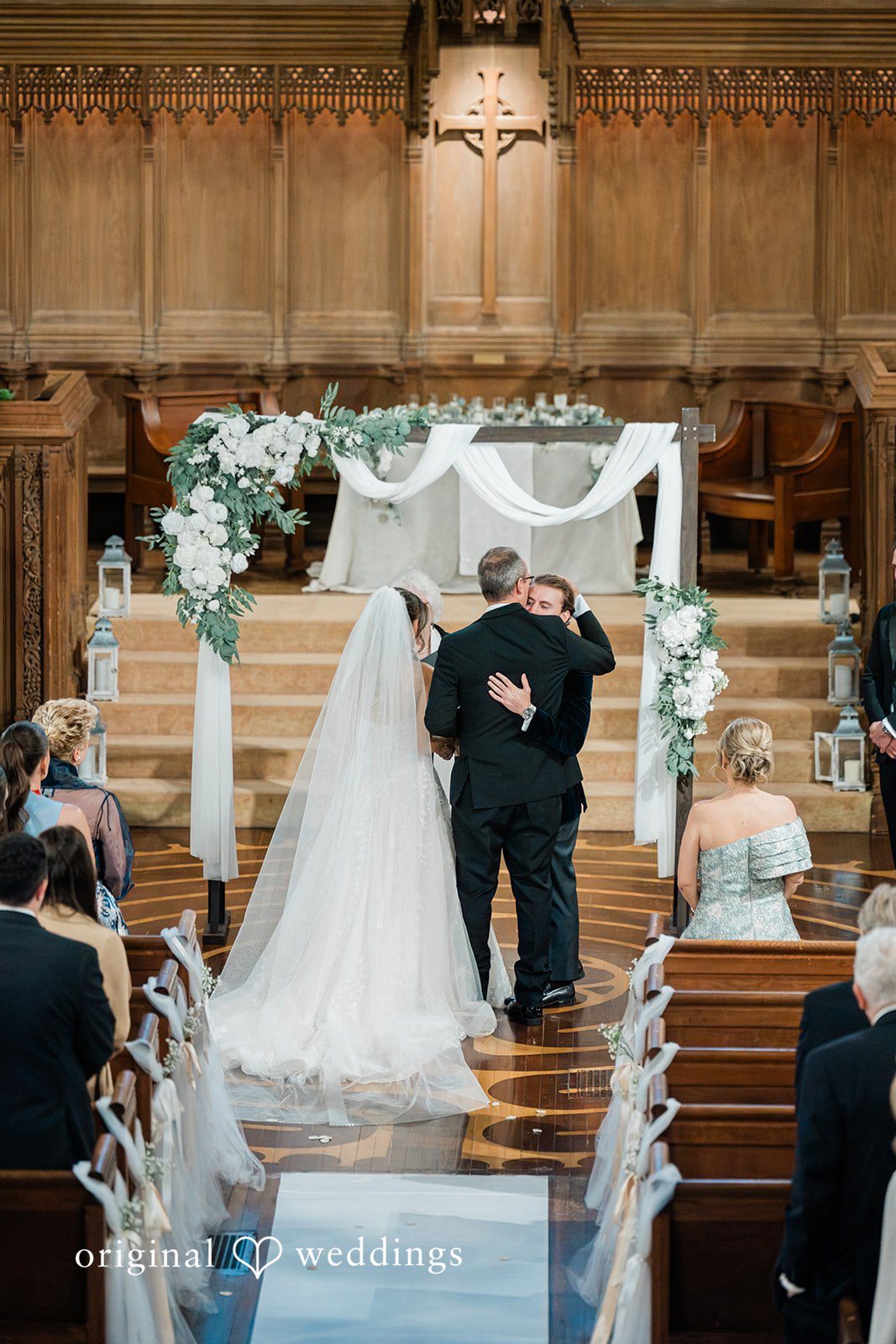 Rear view of a bride and groom standing at an altar at Essex Country Country Club.