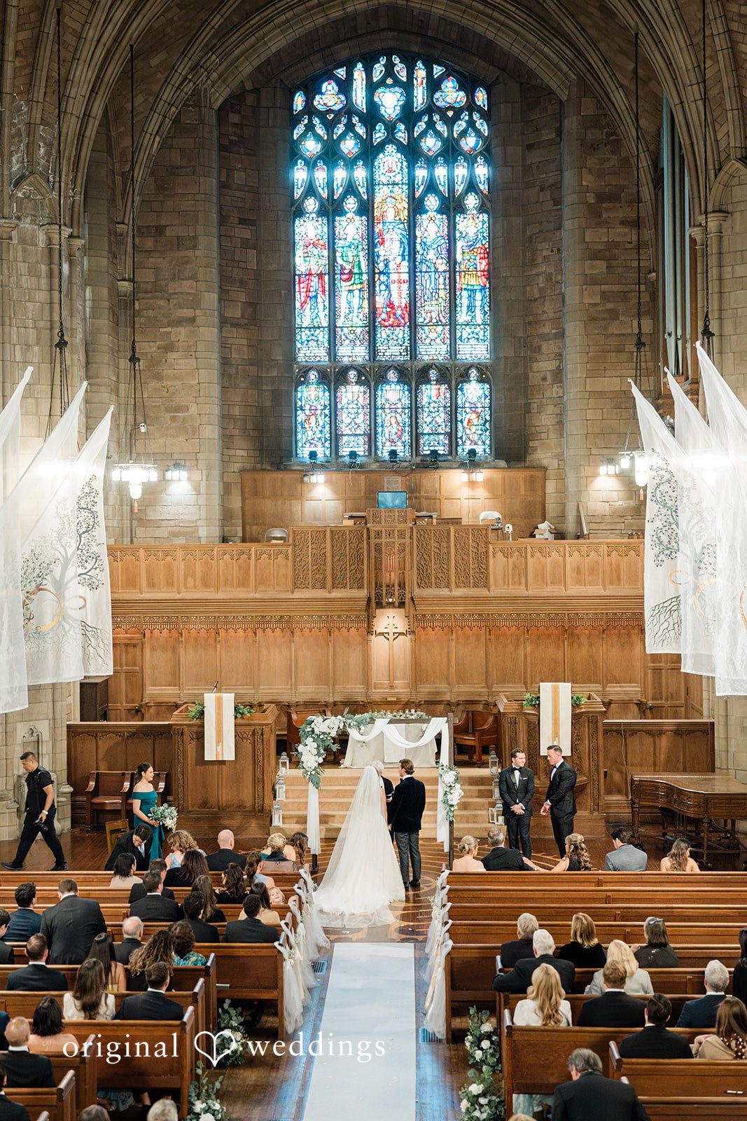 High-angle view of a wedding ceremony in progress inside a large stone church.