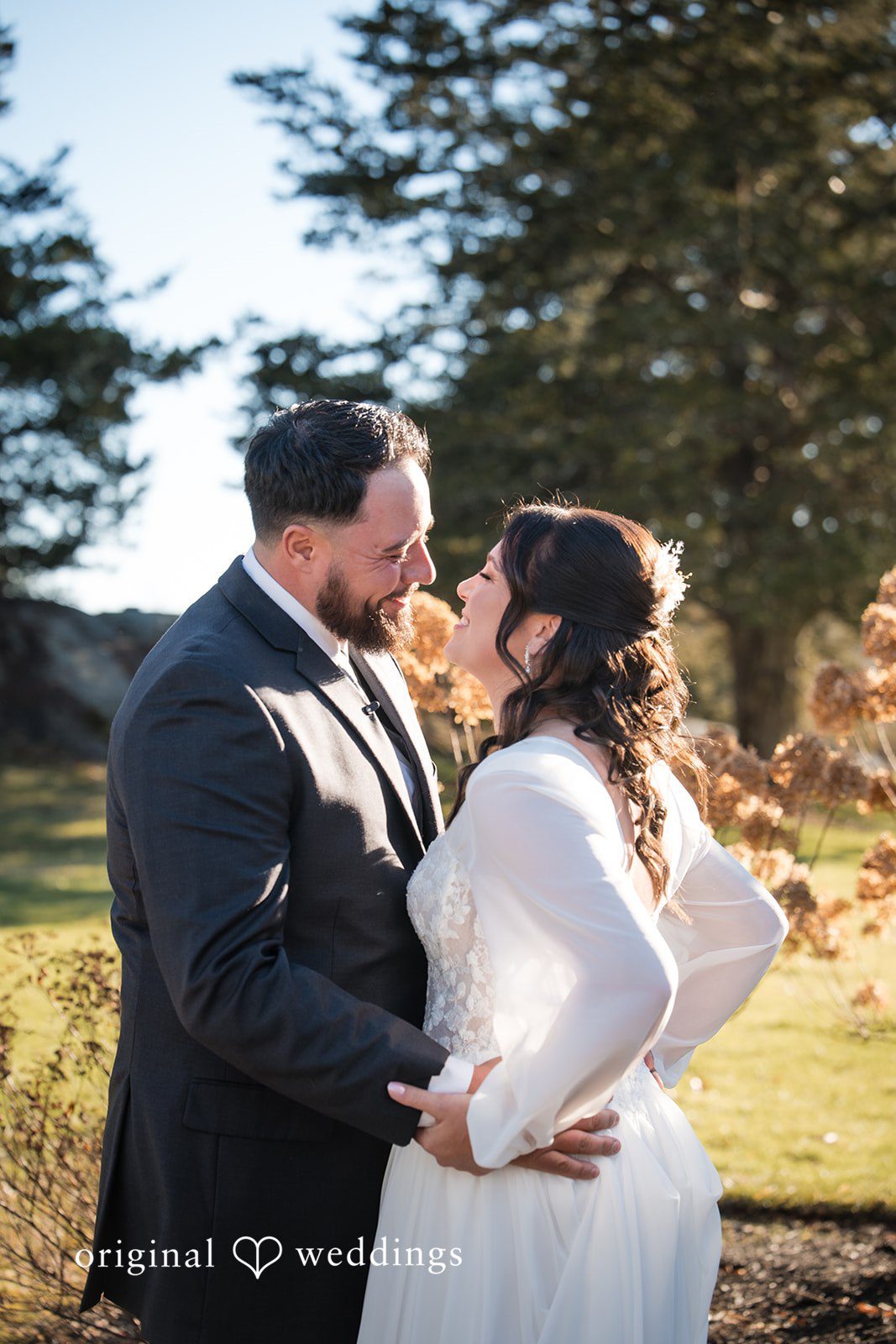 Carolyn + Robert Bride and groom posing in warm sunlight.