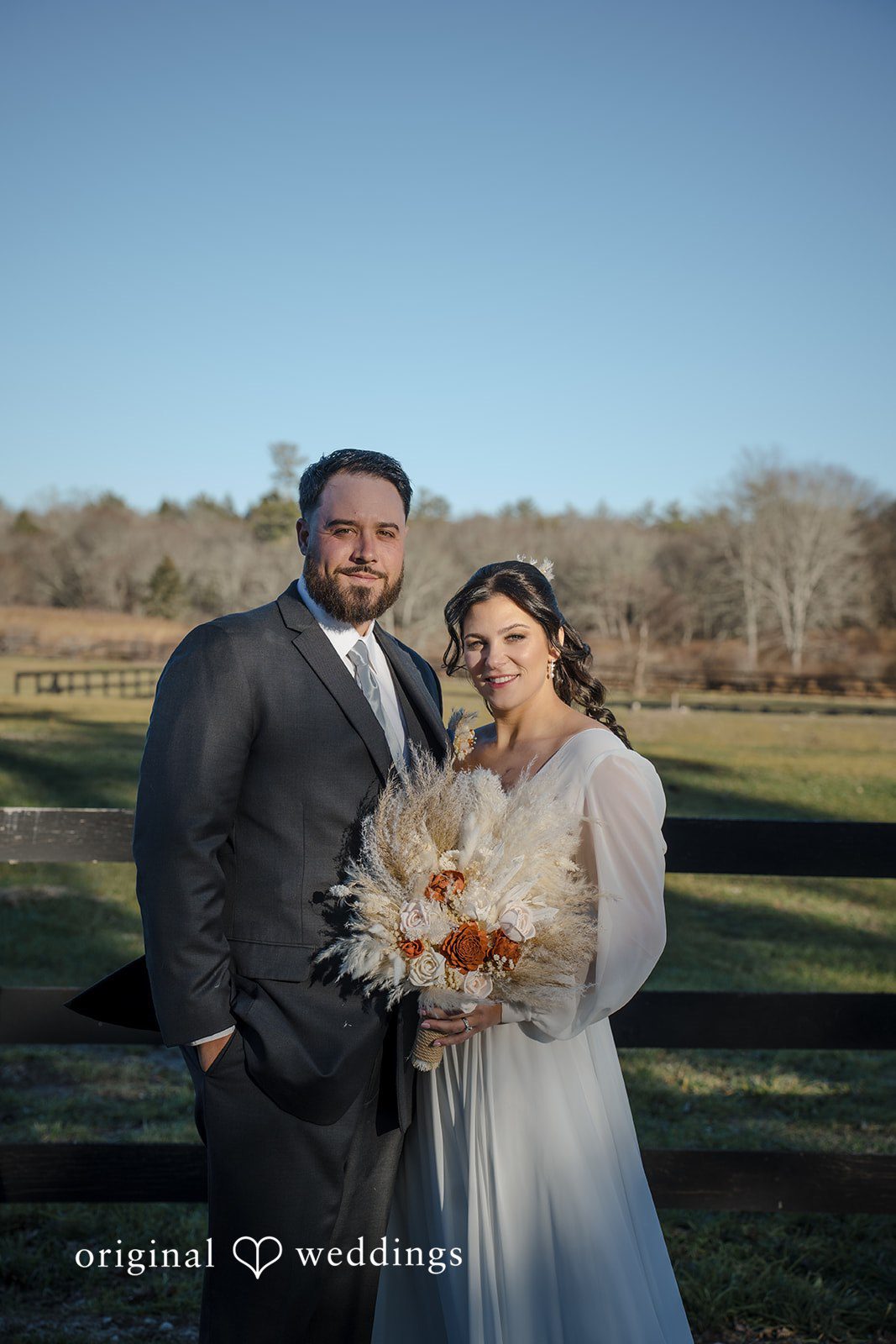 Carolyn + Robert Formal portrait of the bride and groom holding a bouquet.