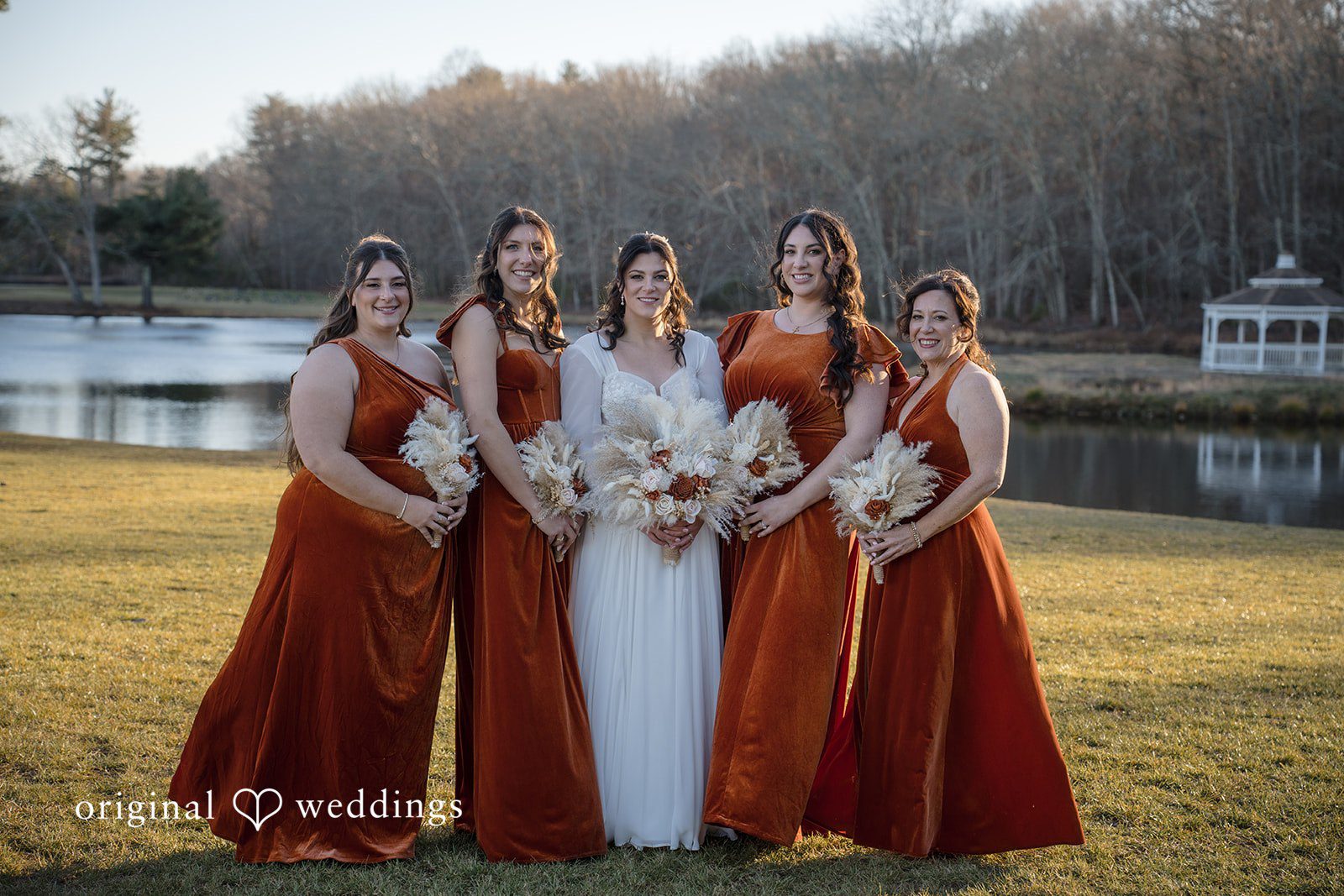 Carolyn + Robert Bridesmaids posing together with bouquets and coordinated attire.