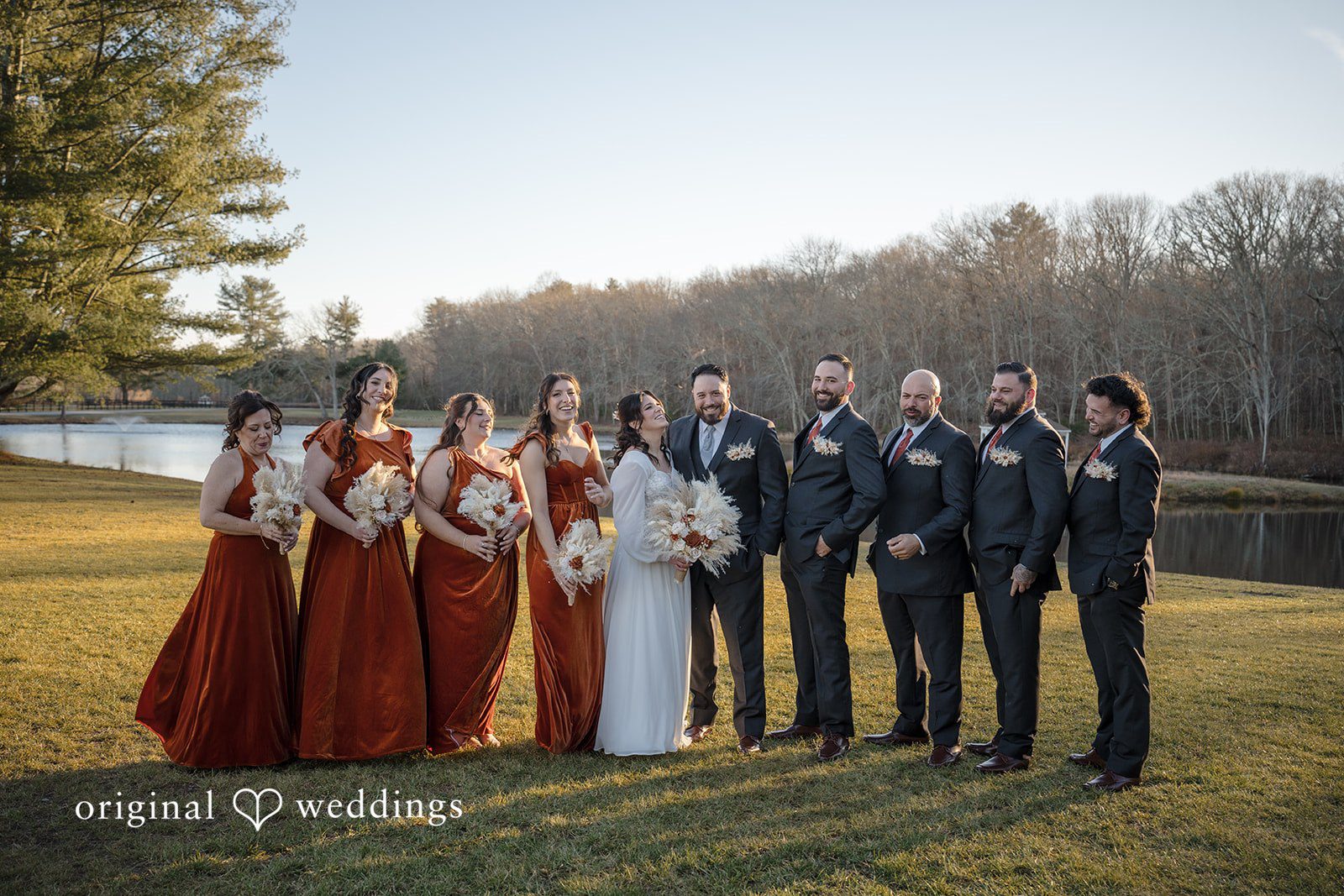 Carolyn + Robert Wedding party posing outdoors with bridesmaids and groomsmen.