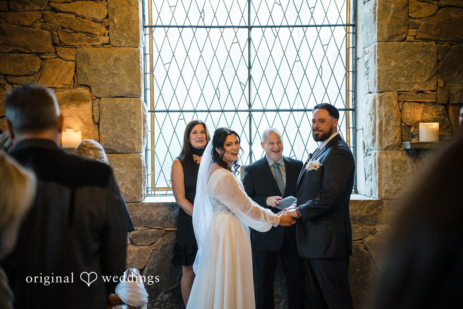 Carolyn + Robert Wedding ceremony exchange taking place in a historic stone setting.