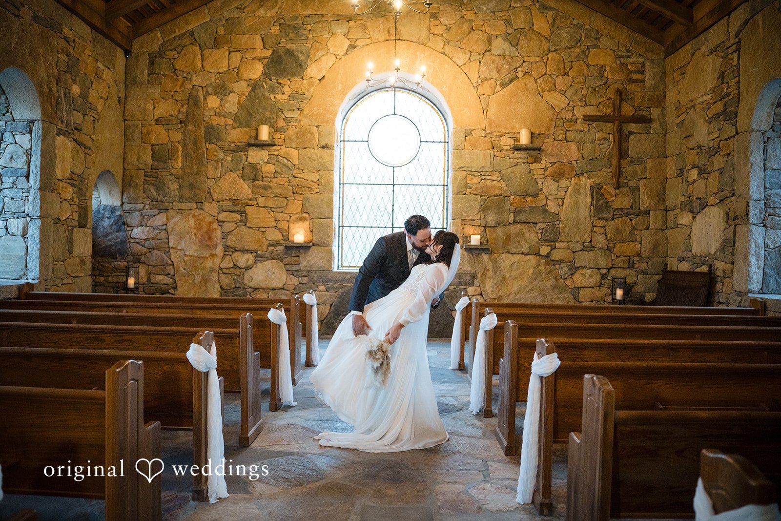 Carolyn + Robert Bride and groom embracing in the church aisle after their ceremony.