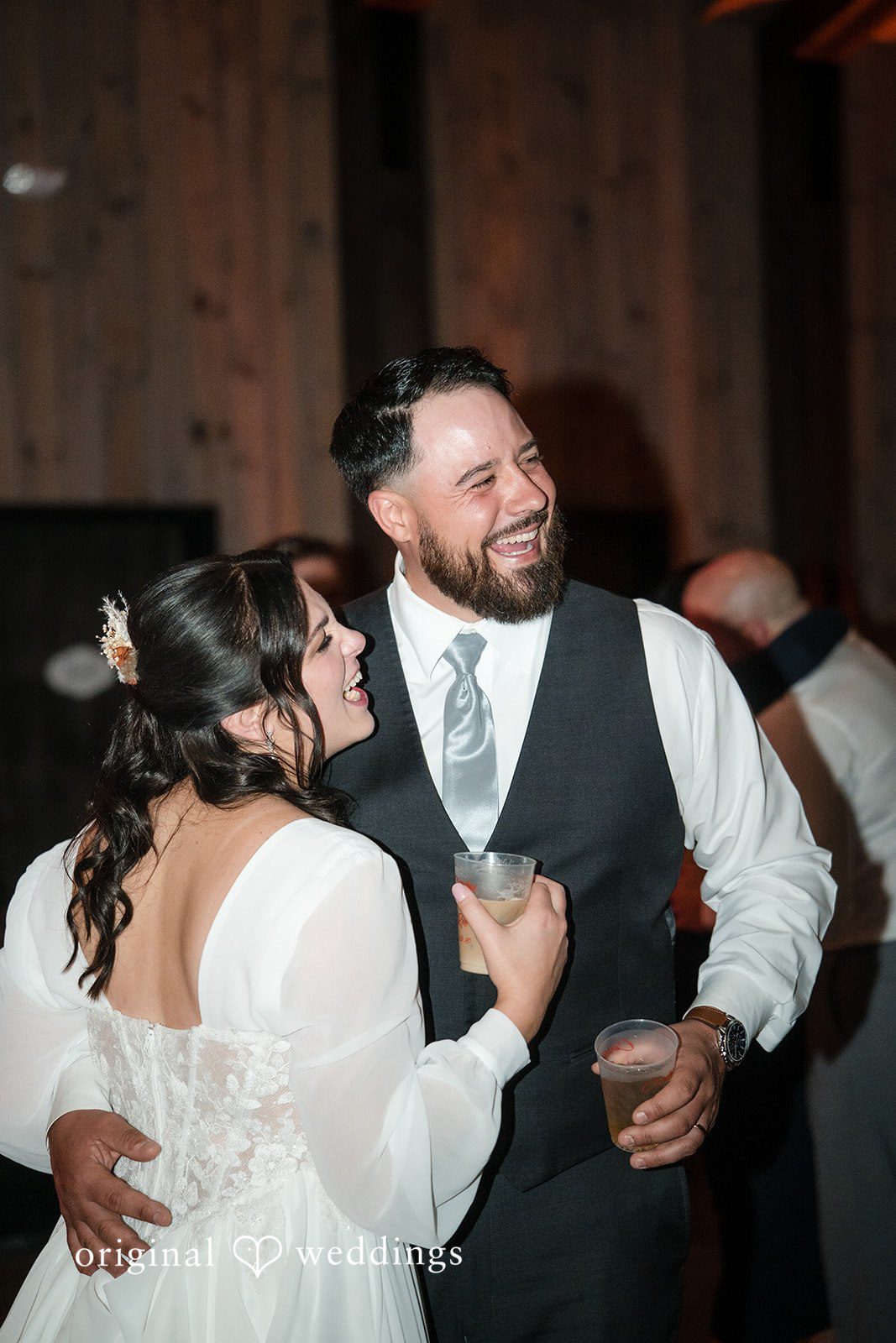 Carolyn + Robert Bride and groom smiling while dancing together at the wedding celebration.
