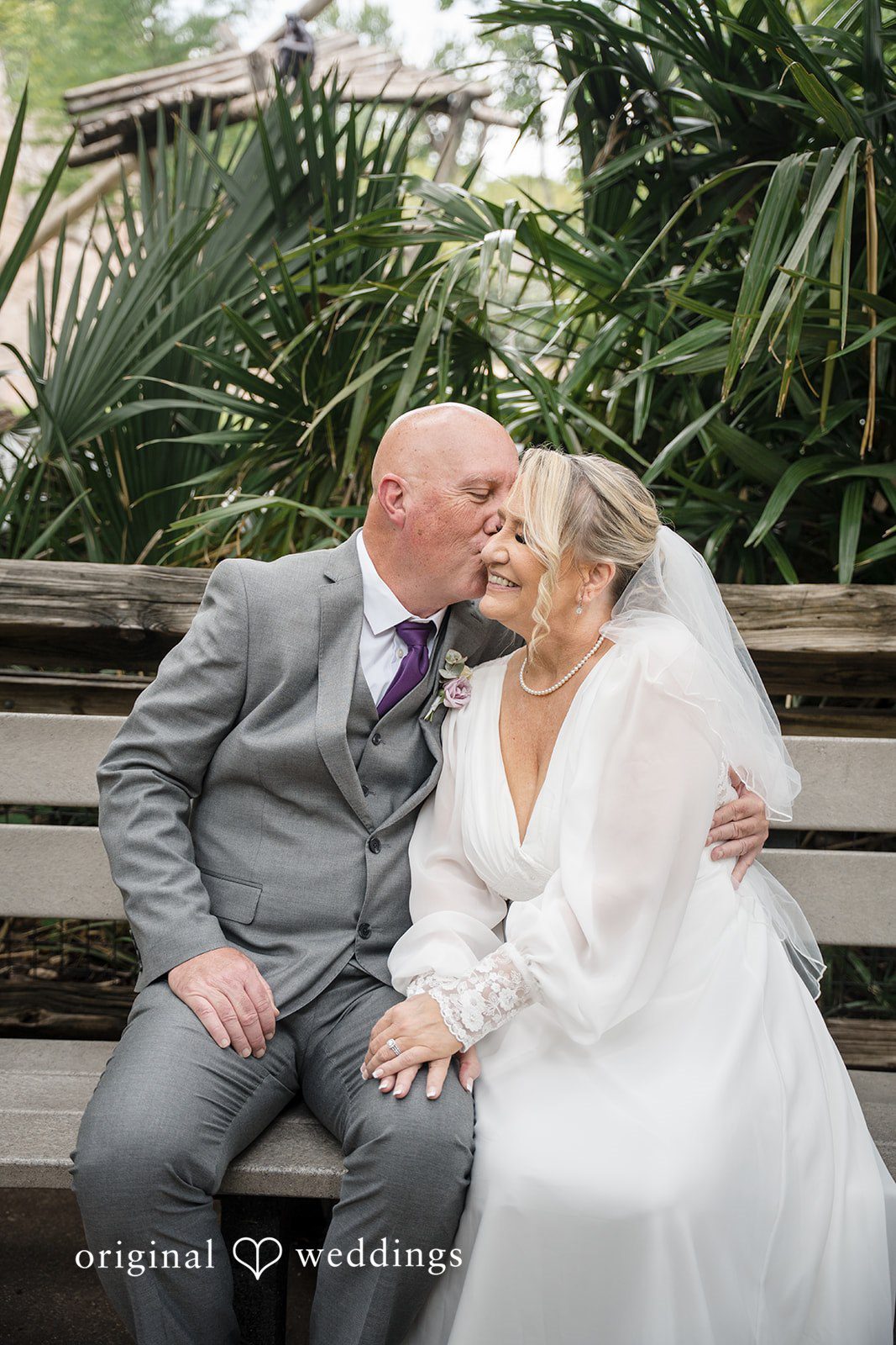 Lorene + Brad Bride and groom sitting together on a bench