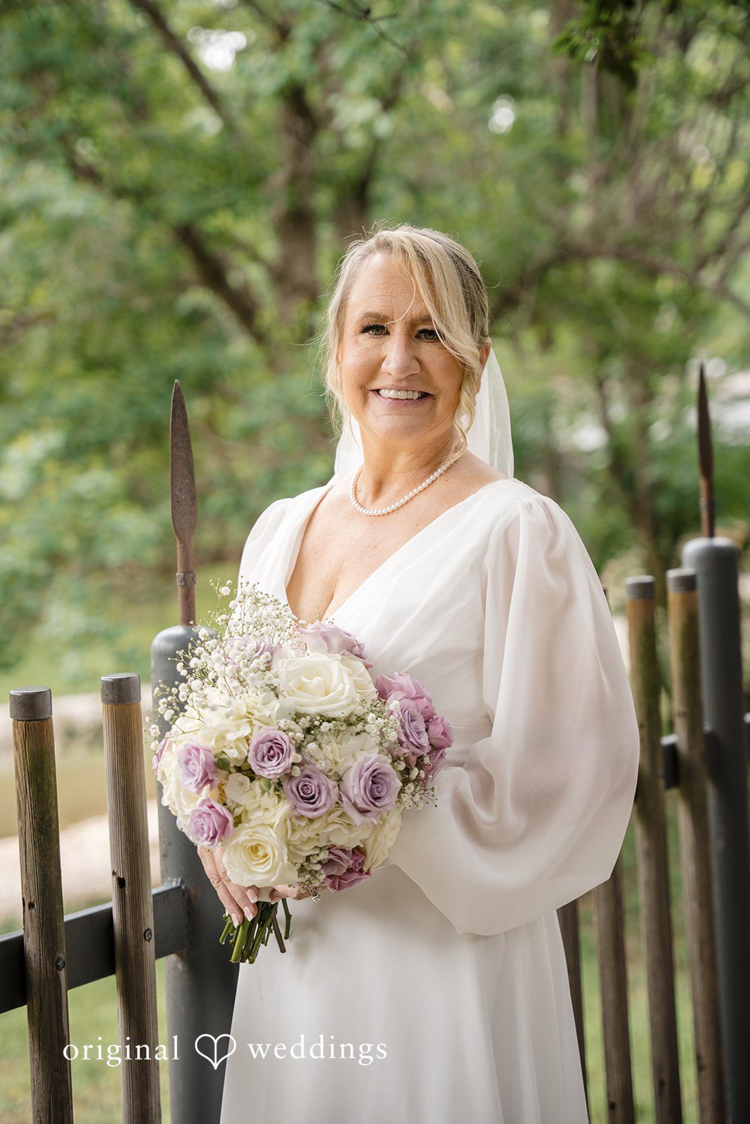 Lorene + Brad Bride holding her bouquet in a full-length portrait