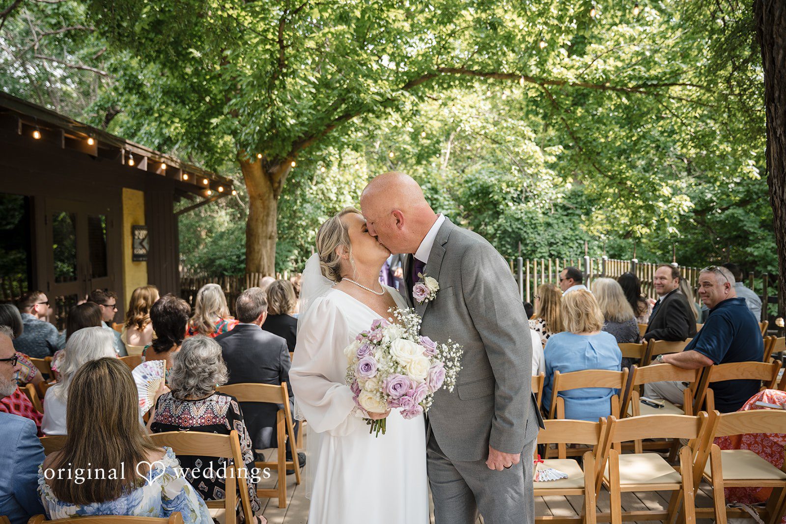 Lorene + Brad Wide-angle portrait of the couple kissing after the ceremony